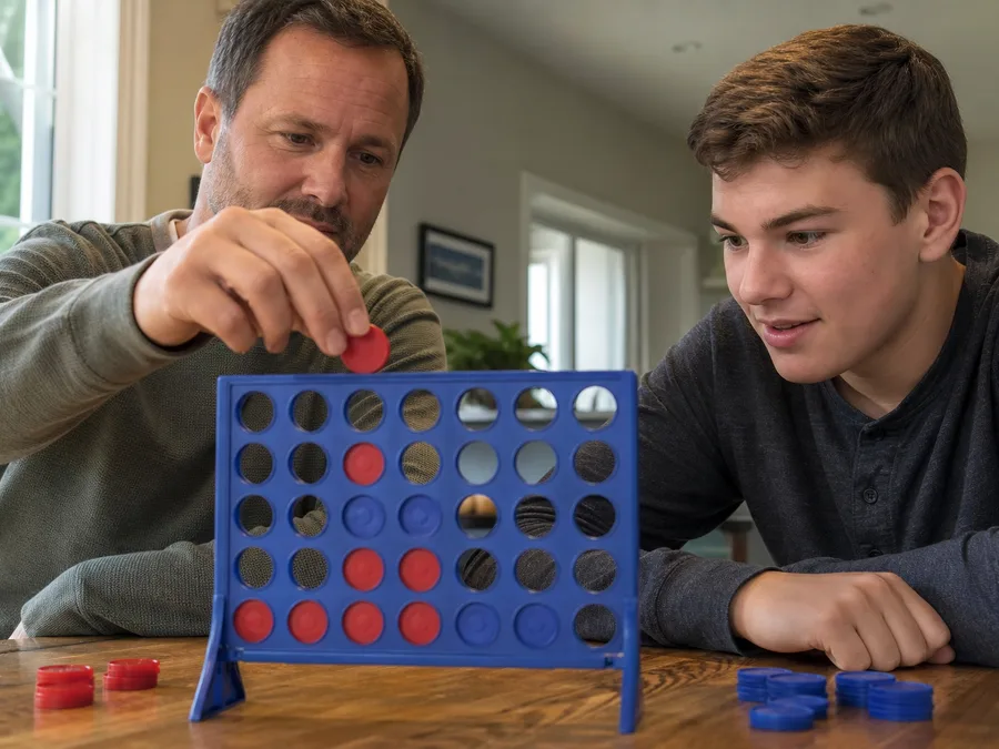 Two players switching who sits red in a same-screen Four in a Row game